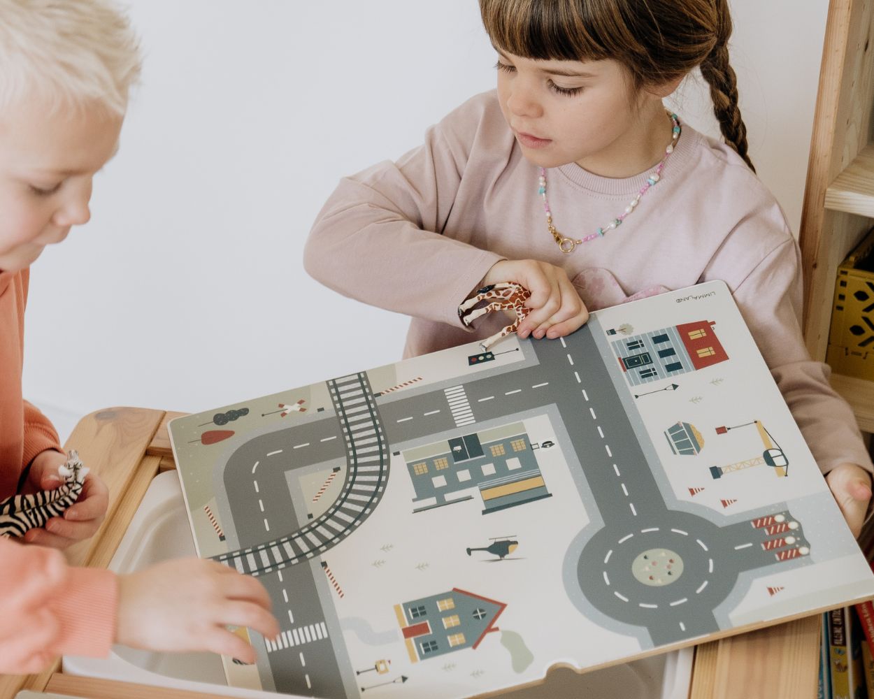 Kinder spielen am IKEA FLISAT Spieltisch auf der Spielstraße